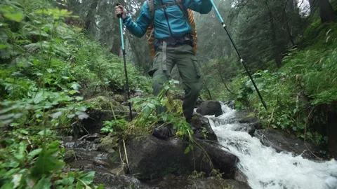 A man with a backpack goes to the mountains in a beautiful river landscape. Stock Footage 217395704