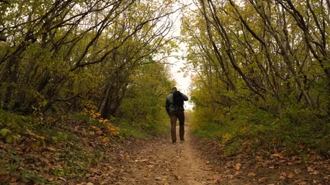 A man with a backpack goes up the path Video stock 143830053