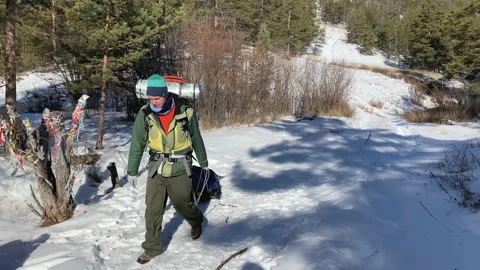 A man with a backpack goes on a winter hike Stock-Footage 151065818