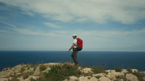 Man with backpack hike on ridge of mountain cliff Stock-Footage 143919652
