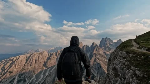 Man with backpack hiking and climbing Dolomites mountain Video stock 248388998