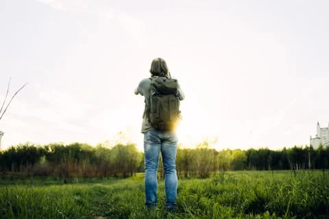 A man with a backpack on his back against the backdrop Stock Photos