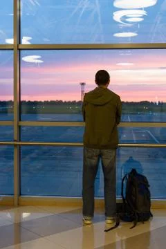 Man with a backpack looks at the planes Stock Photos