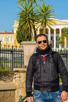 Man with backpack posing in front of Zappeion Hall in Athens, Greece. Stock Photos