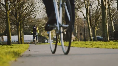 Man with backpack riding his bicycle along urban bike path Stock Footage 77662030
