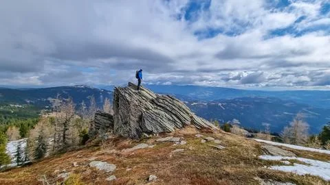 Man with backpack standing on massive rock formation at Steinerne Hochzeit,.. Stock Photos