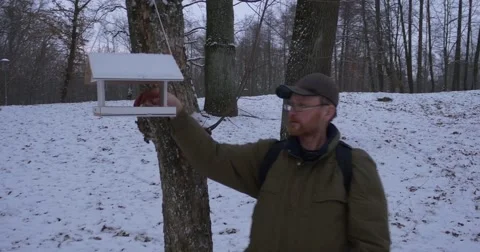 Man With Backpack Stands Near The Tree In Park And Puts Something Into The Stock Footage 59000069