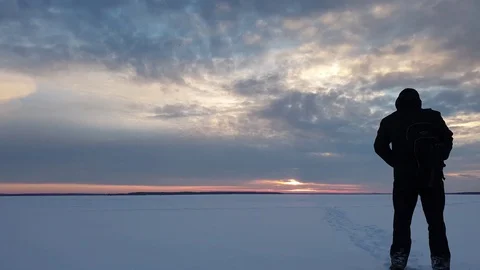 Man with a backpack at sunset in winter. Stock Footage 101393187