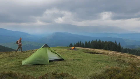 A man with a backpack travels in the mountains Stock Footage 256142922