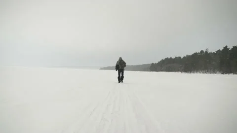 A man with a backpack travels through the forest in winter. North Karelia. Video stock 169098608