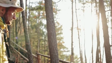 Man with backpack trekking in woods Video stock 85462494