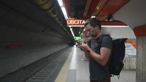 Man with a backpack waits for the subway in Rome, Italy, on a summer day. Using Stock Footage 316979505