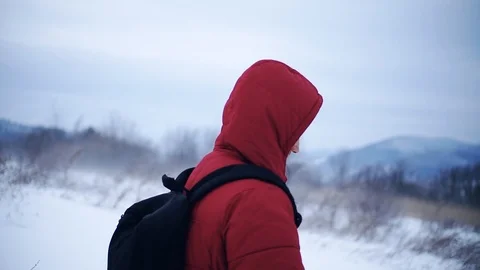 Man with backpack walk along in mountains winter lifestyle equipment adventure Stock Footage 105204861