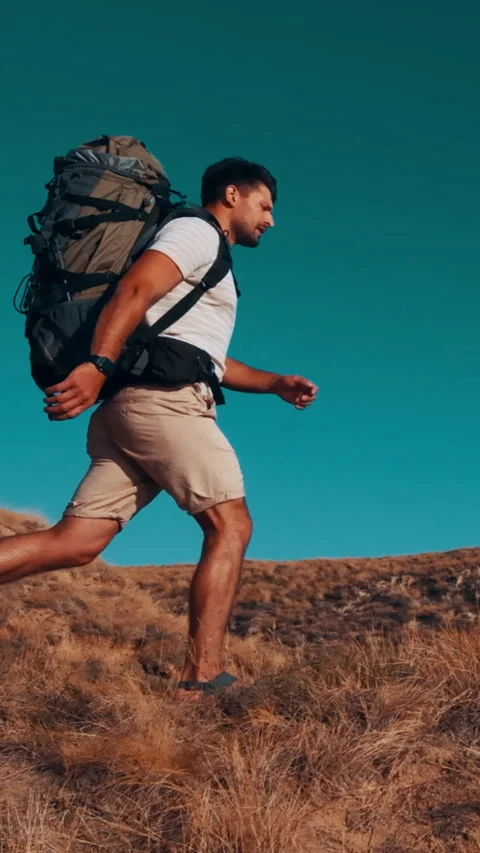 The man with backpack walking on the mountain. slow motion Stock Footage 242128033