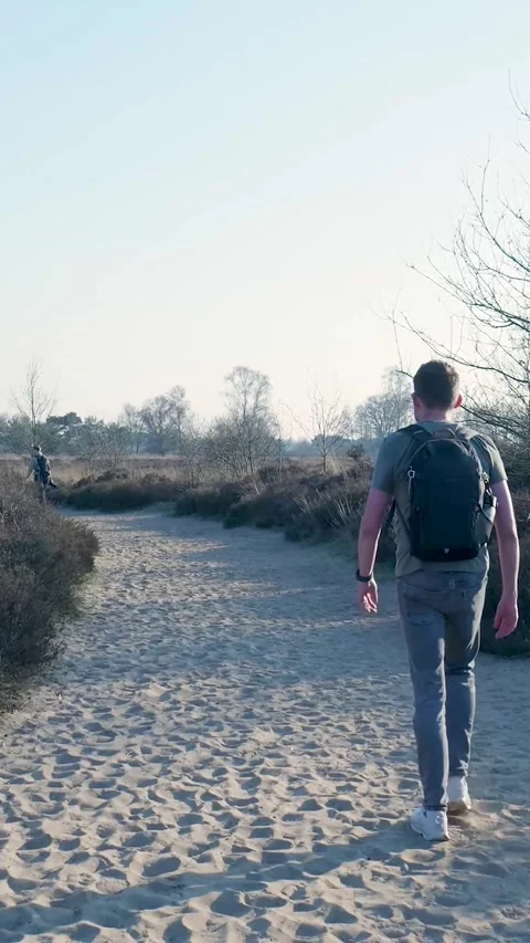 Man With Backpack Walking On Sandy Path In Nature 库存影片 335477581