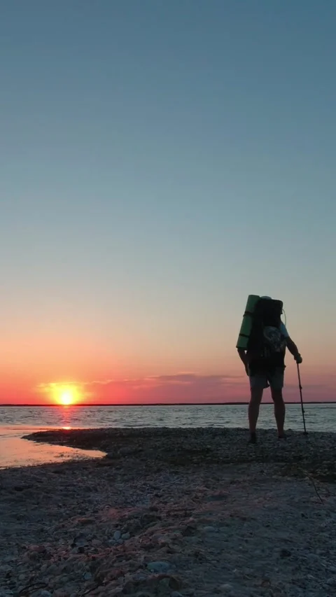 A man with a backpack walks along the Kinburn Spit in the early morning. Ve.. Stock Footage 270214307