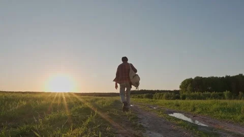 A man with a backpack walks into the sunset 動画素材 197440408