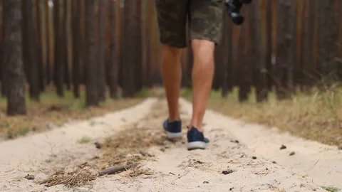 Man with backpack while hiking in the forest or mountains. Narrow focus 库存影片 150260346