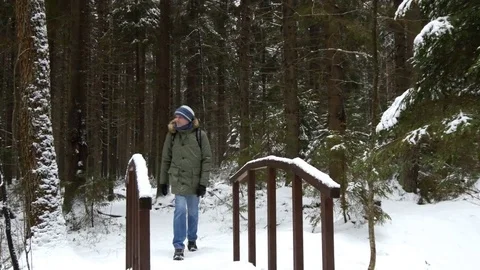 Man with backpack in a winter forest Video stock 80206897