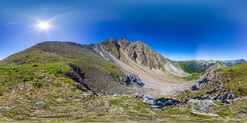 Man backpacker stands on top in the mountains. Spherical panorama 360vr Stock Photos