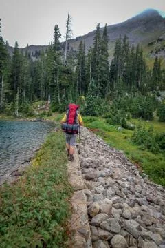 Man Backpacking in the Mountains With a Red Backpack Stock Photos