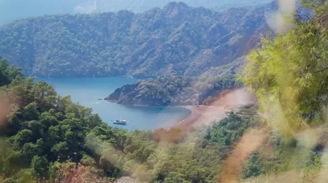 Man with backpacking passes in front of the beautiful sea lagoon with the ship Stock Footage 59777381
