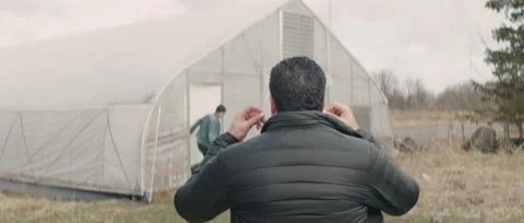 Man Backview Walking to Greenhouse Stock Footage 202138175