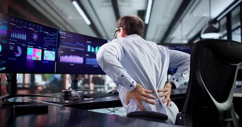 Man With Bad Posture Suffering From Back Pain In Office. Stock-Fotos