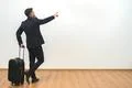 The man with a bag gesturing on the white wall background Photo