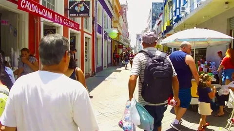 A man with a bag selling stuff in busy downtown area in the city of Florianop Stock Footage 104210636