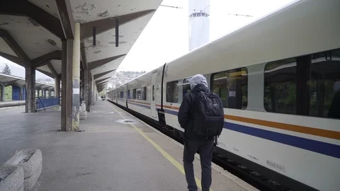 Man with bag walking at train station Video stock 114696950