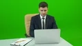 The man with a bag working at the desk on the green background 4k or 4k+ Resolution