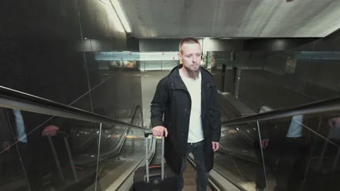Man with baggage moving up on escalator. Subway underground station Stock Footage 132014513