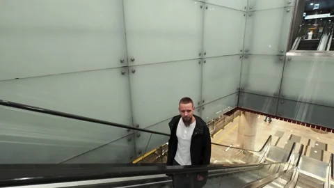 Man with baggage moving up on escalator. Subway underground station Video stock 132018634
