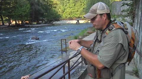 Man Baits Fishing Hook For Another Person Stock Footage 24704670