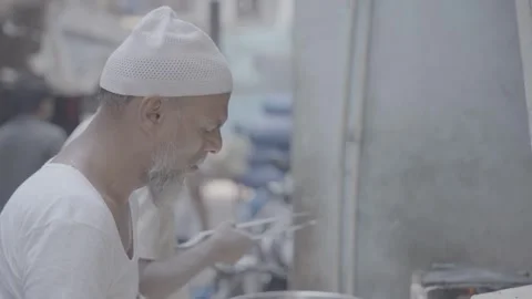 A man baking bread in Mumbai, India Video stock 345387435