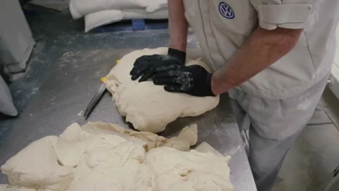 Man baking bread. Sprinkling some flour on dough. Hands kneading dough. Close up Stock-Footage 169141762