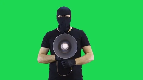 A man in a balaclava,shouting at a shout,green screen background Stock Footage 129042481