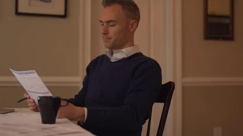 A man balancing his checkbook Stock Footage 70256359