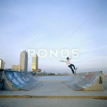 Man Balancing Skateboard On Ramp