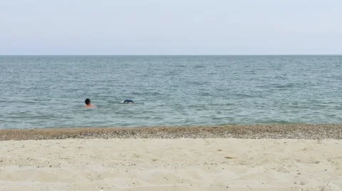 Man balancing upside down in water on hands with legs in the air. Stock Footage 66276186