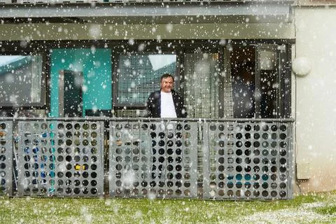 A man at the balcone in during snow. Stock Photos