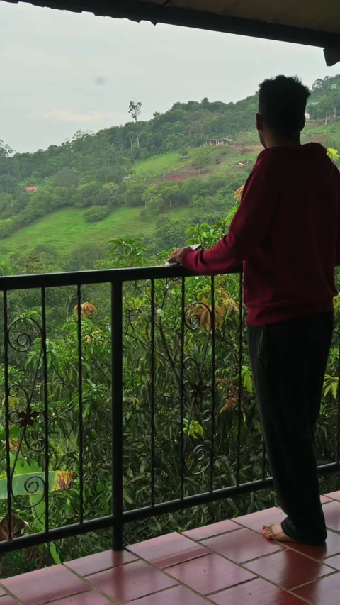 Man on Balcony Drinking Coffee. 動画素材 330085488