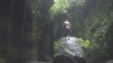 Man in Bali Cave Slow Motion Rain Stock Footage 106151961