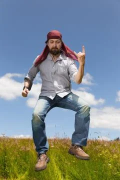 Man with bandana forms the devils hand Stock Photos