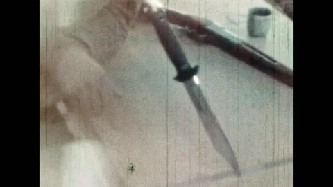 Man bandit portrait throwing knife at table, close up. Male robber Stock Footage 283549286