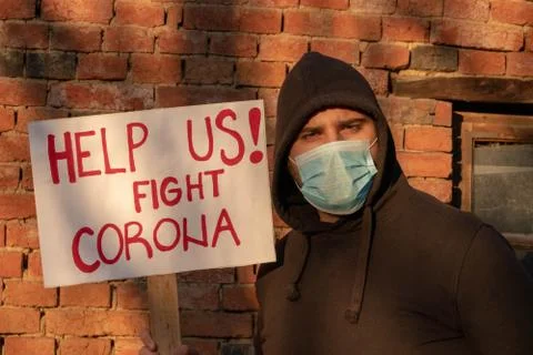 Man with banner " Help us! Fight Coronavirus " Man protests, calling governme Stock Photos