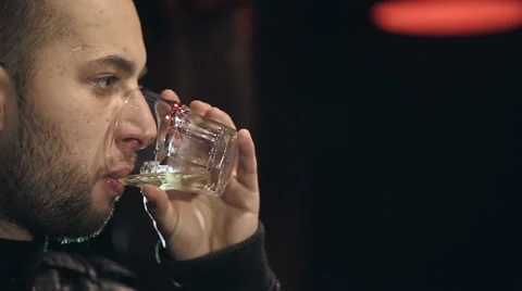 The man at the bar drinking whiskey with ice Stock Footage 43875455