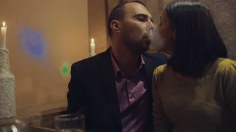 A man in a bar drinks whiskey and smokes a cigarette 스톡 동영상 95938764