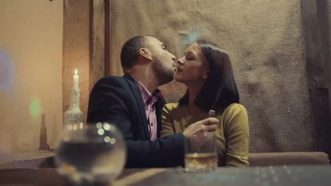 A man in a bar drinks whiskey and smokes a cigarette 스톡 동영상 95939141